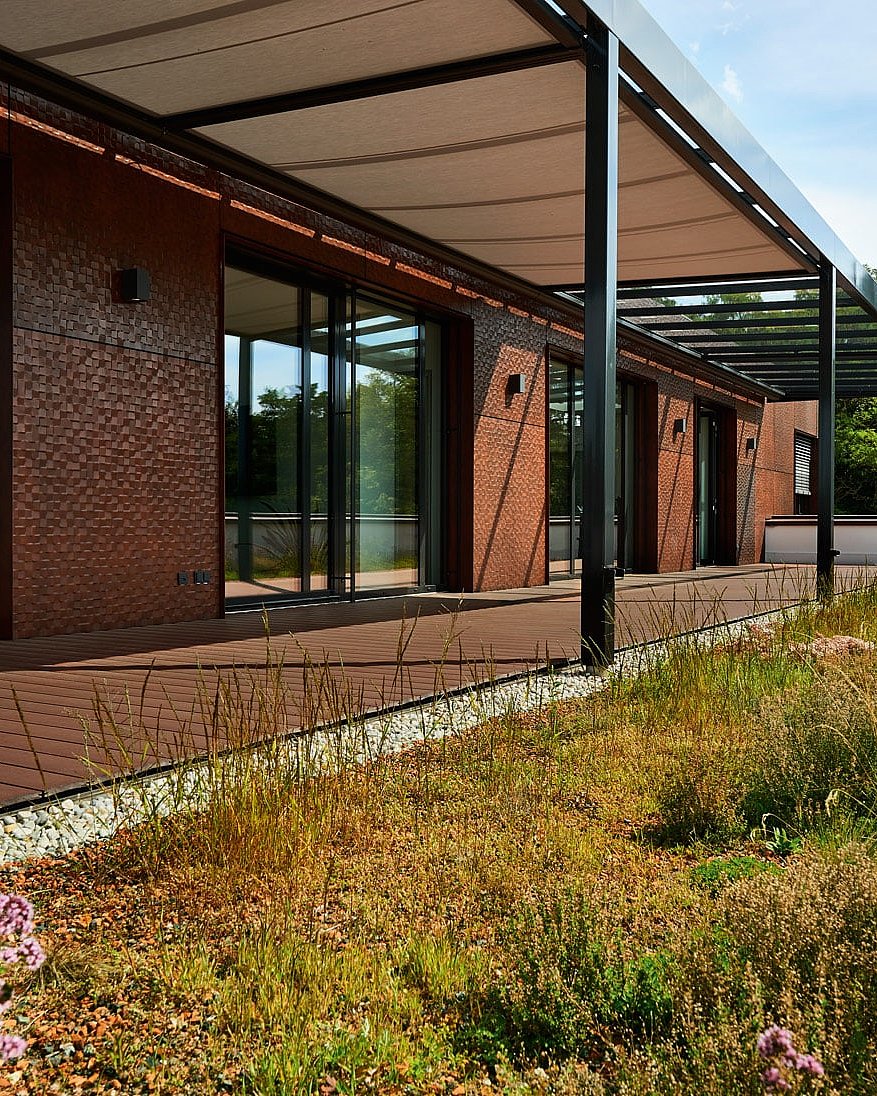 The smart one in brown from NaturinForm laid out in front of a residential building